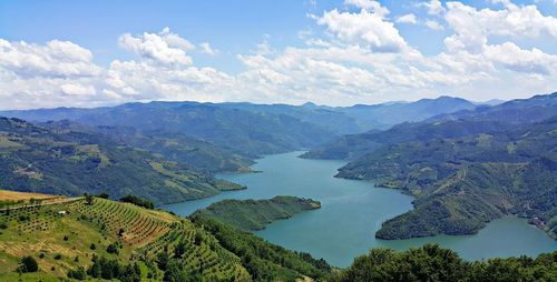 Scenic view of mountains against cloudy sky