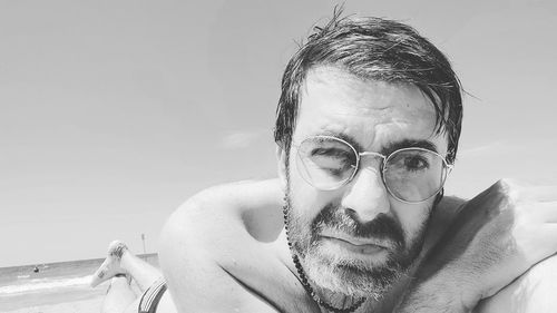 Portrait of young man against sky