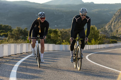 Cyclists cycling with each other on costa blanca mountain pass in alicante, spain