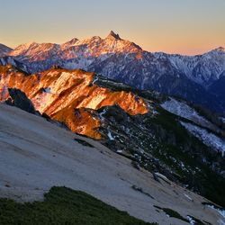 Scenic view of snowcapped mountains against sky during sunset