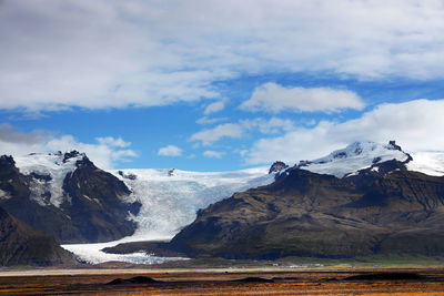 Scenic view of snowcapped mountains against sky