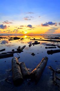 Reflection of clouds in sea at sunset