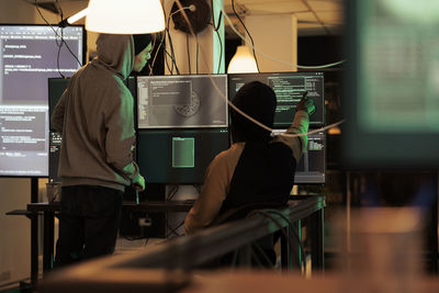 Rear view of woman using mobile phone in cafe