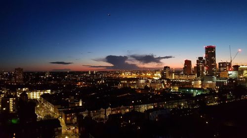 Aerial view of city lit up at night