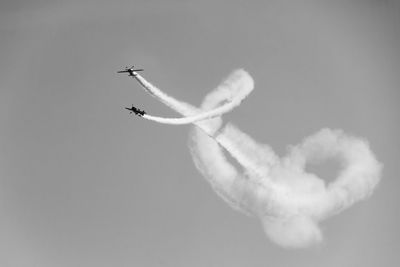 Low angle view of airplane flying against sky