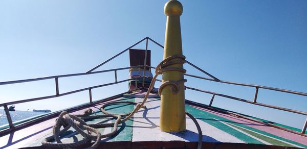 Low angle view of ship against clear blue sky