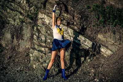 Full length of woman standing on rock