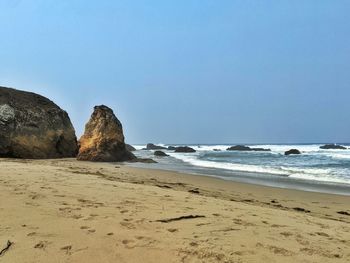 Scenic view of beach against clear sky