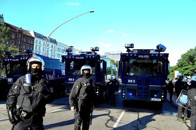 Panoramic shot of people standing on street against sky