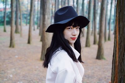 Portrait of beautiful young woman in hat