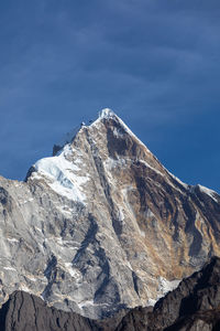 Scenic view of snowcapped mountain against blue sky