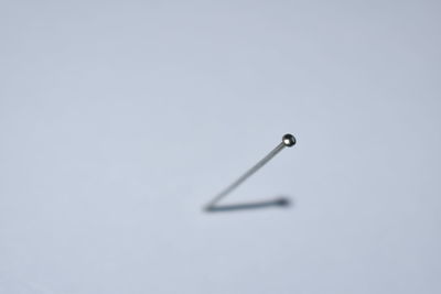 Close-up of drop on table against white background