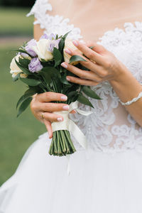 Wedding manicure and bridal bouquet in hand