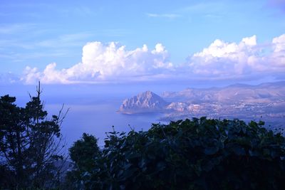 Scenic view of sea and mountains against sky