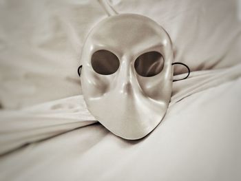 Close-up of mask on bed