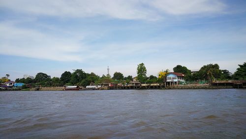 Scenic view of river against cloudy sky