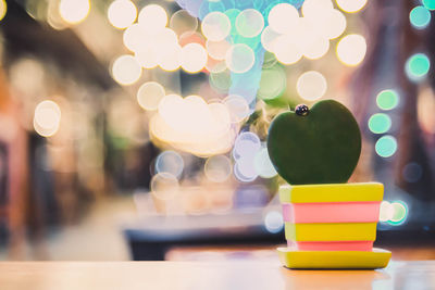 Defocused image of illuminated lights on table