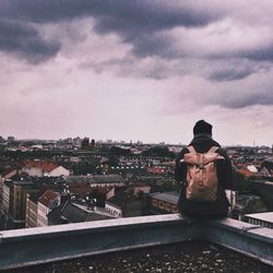 View of cityscape against cloudy sky