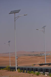 Street light on field against sky