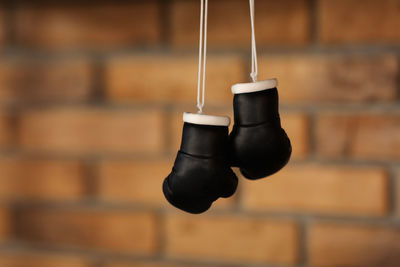 Close-up of shoes hanging on wall