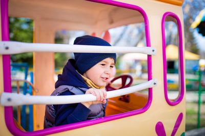 Portrait of boy looking at amusement park
