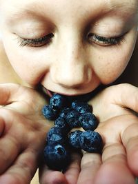 Close-up of girl eating blueberries