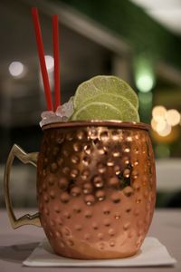 Cocktail with crushed ice and lime in copper mug