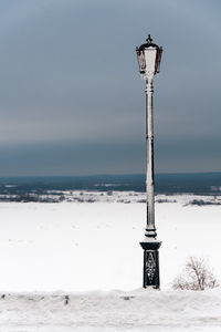 Street light on beach against clear sky