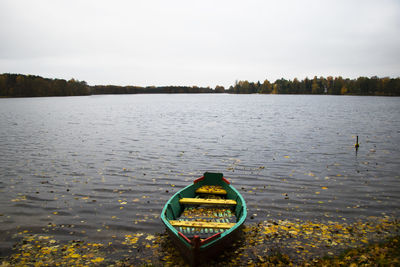 Old wooden boats near the beach of trakai gavle lake, lithuania. autumn and fall time.