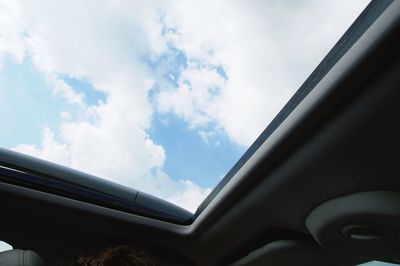 Close-up of airplane window against sky