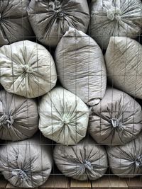 Stack of sacks in metal grate at warehouse