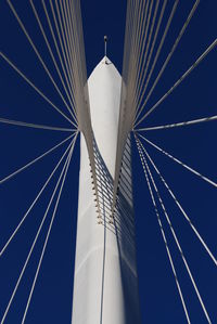 Low angle view of windmill against clear blue sky