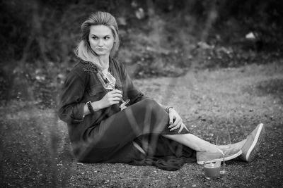 Portrait of woman sitting on field