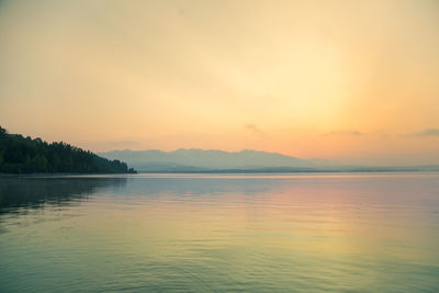 Scenic view of lake against sky during sunset