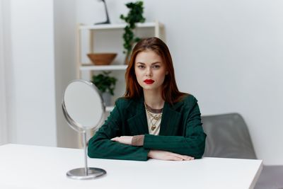 Portrait of young woman using mobile phone at home