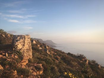 Scenic view of sea and mountains against sky