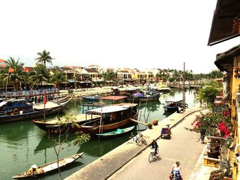 Boats in river with buildings in background