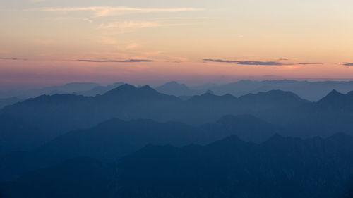 Scenic view of mountains against sky at sunset