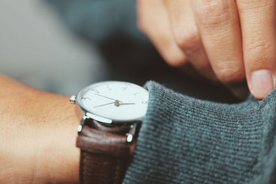 Man checking time he watches - close-up