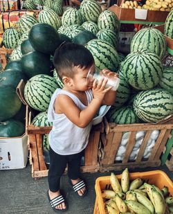 Full length of boy standing at market