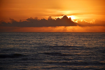 Scenic view of sea against orange sky