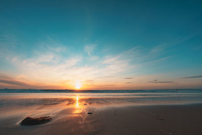 Scenic view of sea against sky at sunset