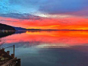 Scenic view of sea against dramatic sky during sunset