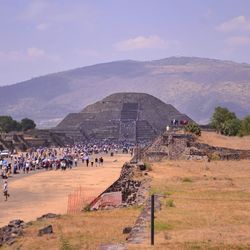 Group of people on landscape against mountain