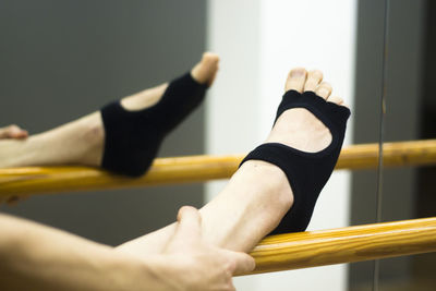 Low section of woman on gymnastics bar