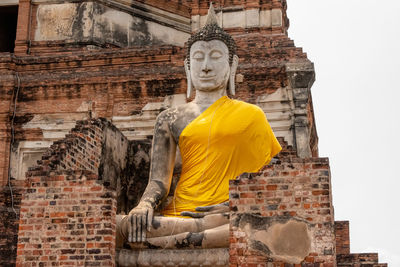 Statue of buddha against building