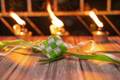 Close-up of burning candles on table