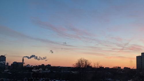 Silhouette buildings against sky during sunset