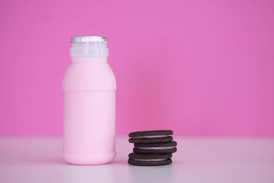Close-up of pink bottles on table