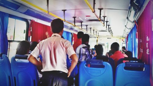 Rear view of people sitting in train